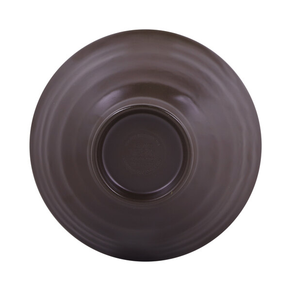 An antique white melamine bowl with a chocolate brown interior and black circle in the middle.