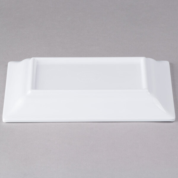 A white rectangular Elite Global Solutions melamine plate on a gray surface.