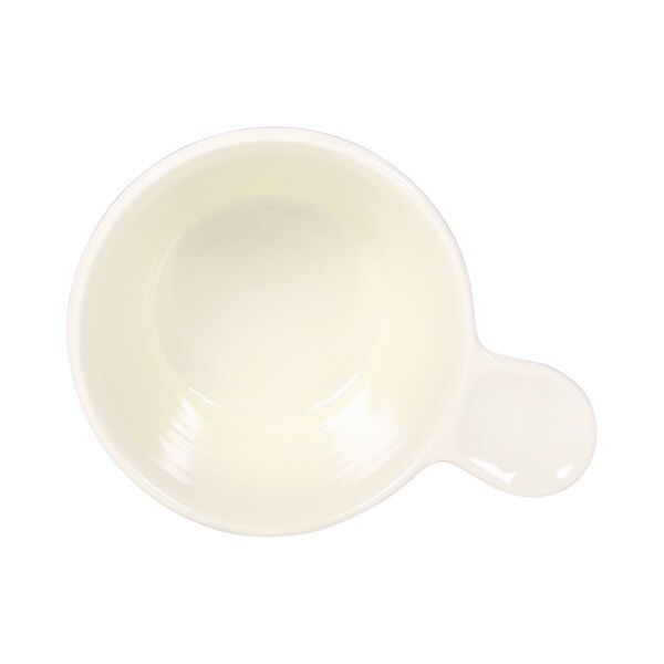 A white bowl with a handle.