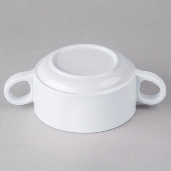 A white bowl with two handles.