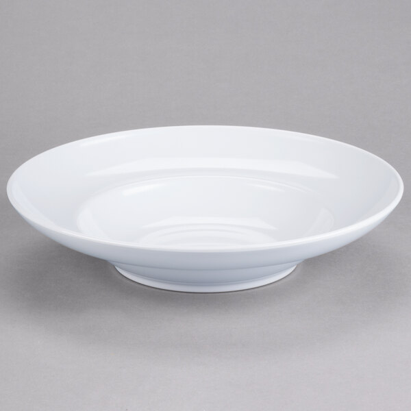 A white bowl with a rim on a gray surface.
