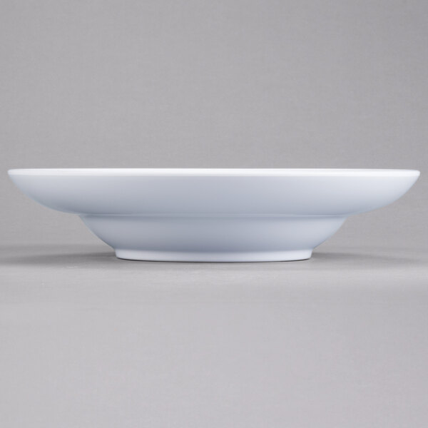 An Elite Global Solutions white melamine bowl on a gray surface.