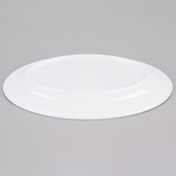 An Elite Global Solutions white melamine oval plate on a gray surface.