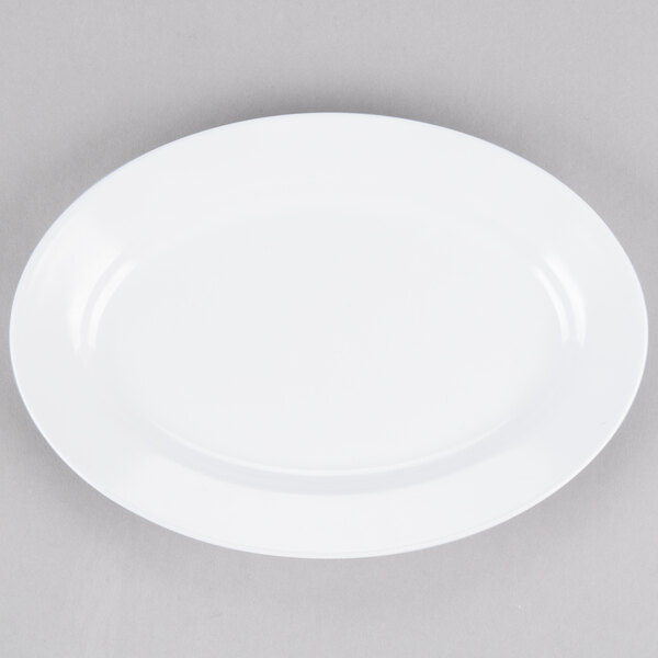 A white Elite Global Solutions oval melamine plate on a gray surface.