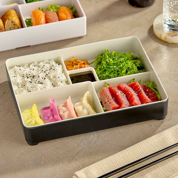 An Elite Global Solutions Karma two-tone melamine bento box with a variety of food in it.