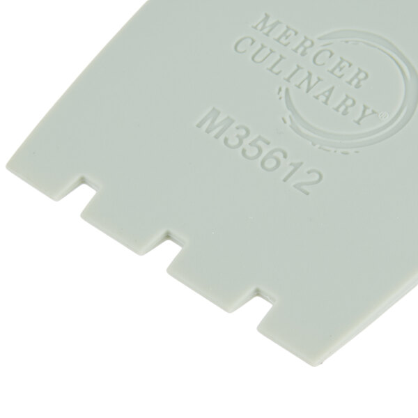A white plastic piece with the words "Mercer Culinary" on it.