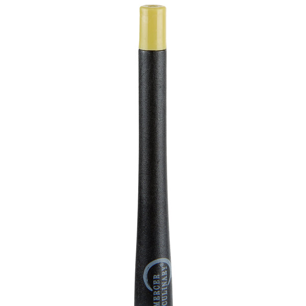 A black and yellow silicone brush with a yellow handle.