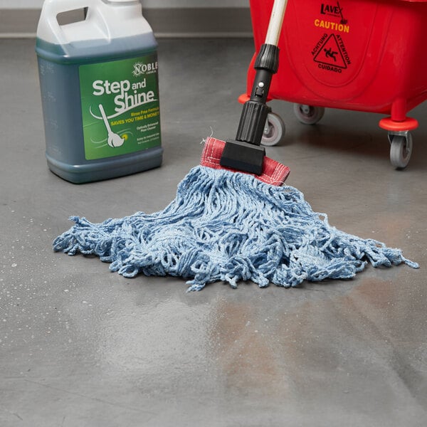A Rubbermaid Blue Blend Looped End Wet Mop in a red bucket next to a bucket of detergent.