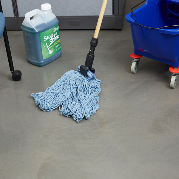 A blue Rubbermaid Looped End Wet Mop in a blue bucket of liquid.
