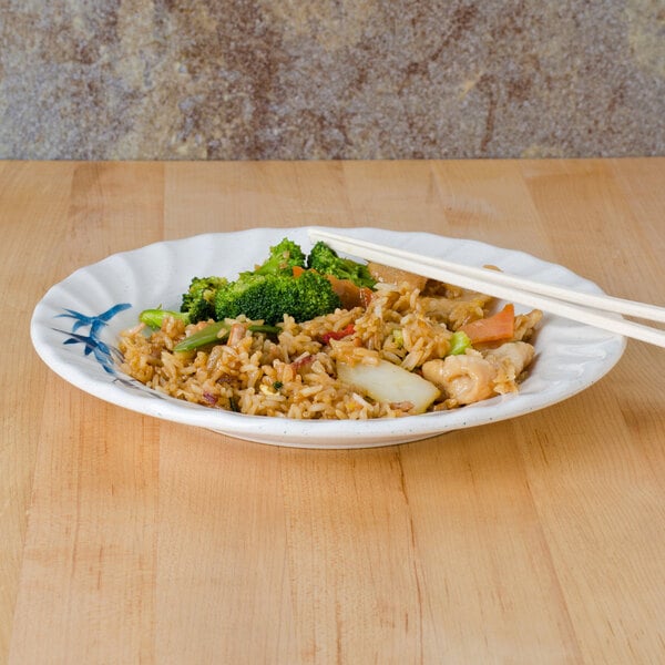 A Blue Bamboo melamine plate with rice, broccoli and chicken with chopsticks.