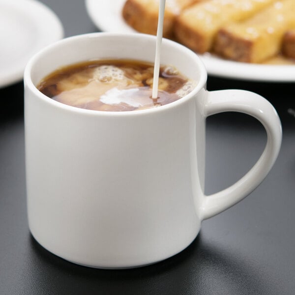 A Libbey Royal Rideau white porcelain mug filled with coffee and milk.
