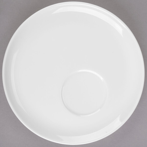 A white Libbey Royal Rideau porcelain saucer with an offset circle.