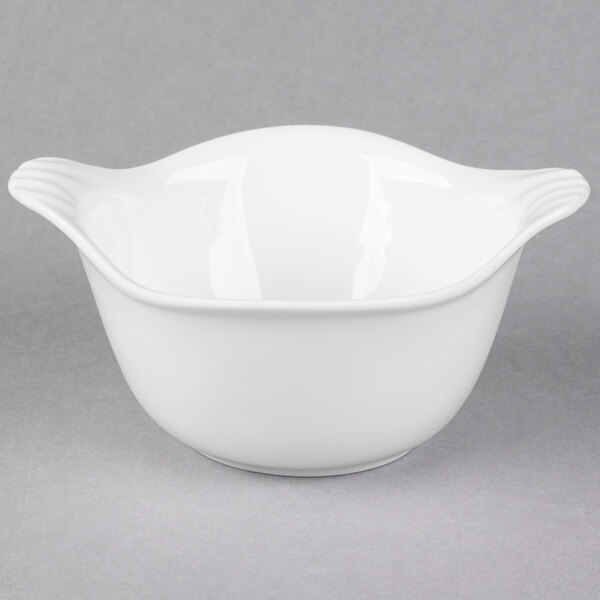 A white bowl with a porcelain handle.