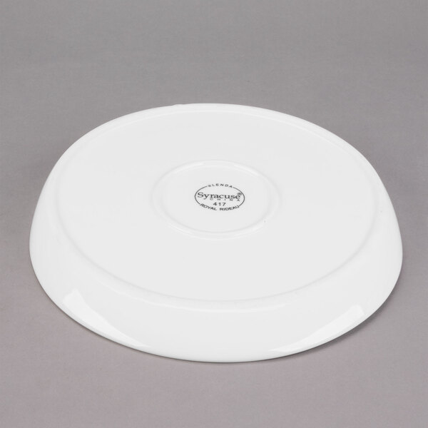 A white Libbey porcelain plate with a circular design on it.