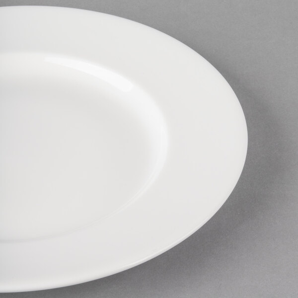 A close-up of a Libbey Royal Rideau white porcelain plate with a wide white rim.