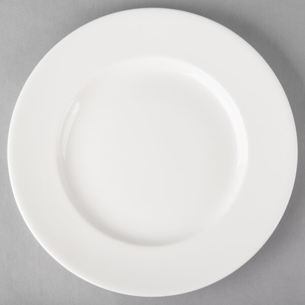 A Libbey white porcelain plate with a wide rim on a gray surface.