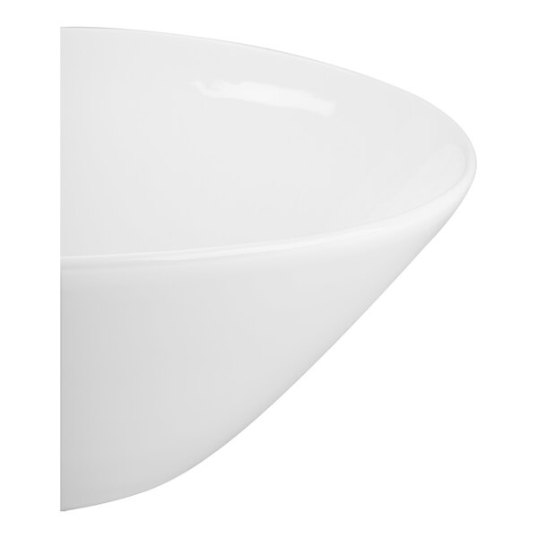 A close-up view of a smooth, white, round bowl with a glossy finish.