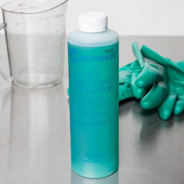 A blue bottle of Manitowoc ice machine cleaner next to gloves.