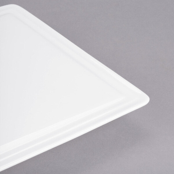 A white rectangular porcelain tray with rounded corners on a gray surface.
