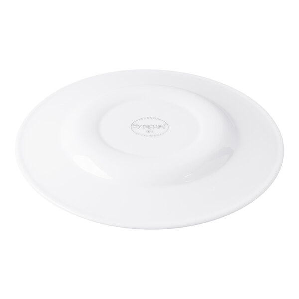 A white porcelain plate shown upside down with a visible maker's mark in the center.