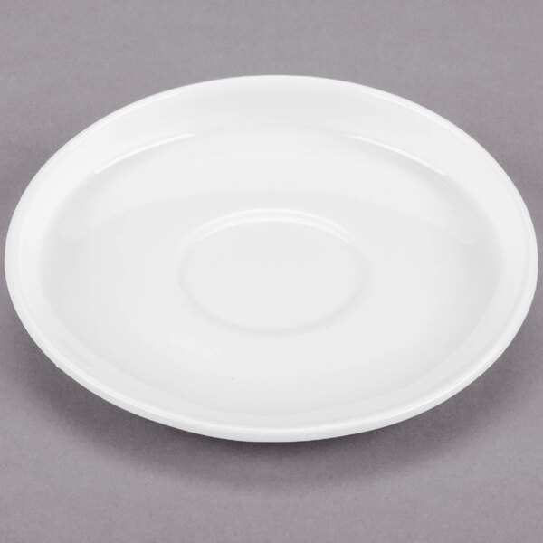A white Libbey porcelain saucer with a circle rim.