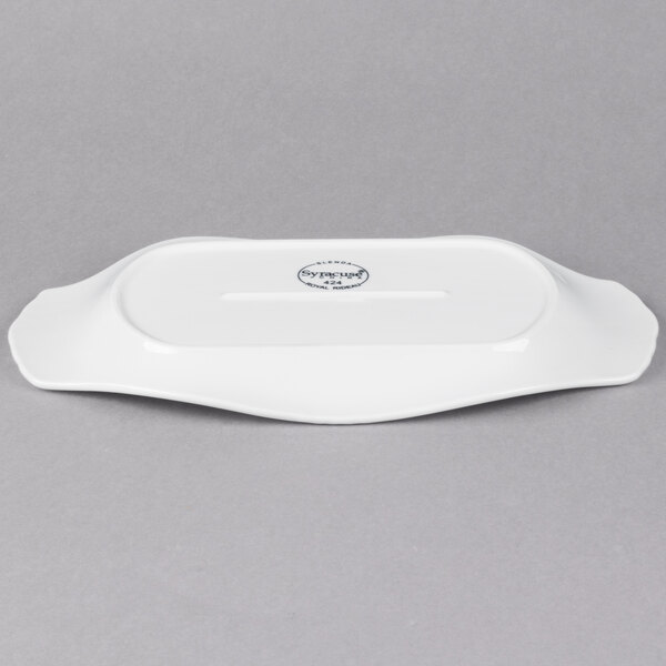 A white rectangular porcelain platter with fluted edges and a handle.