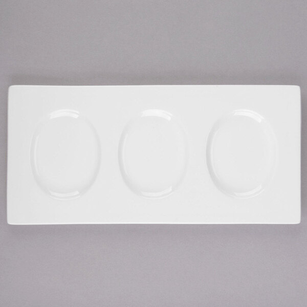 A white rectangular tray with three oval holes for Libbey Royal Rideau white porcelain plates.