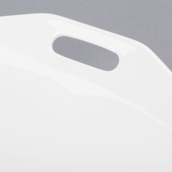 A white porcelain plate with a handle.