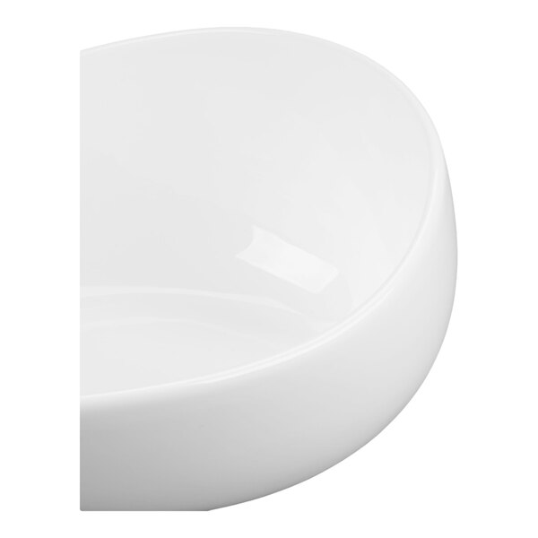 A close-up view of a smooth, glossy white round bowl with curved edges.