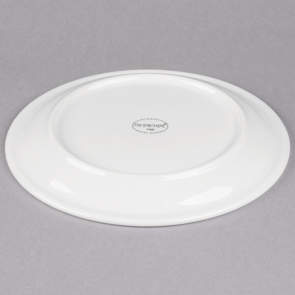 A white Libbey porcelain plate with a narrow rim on a gray background.