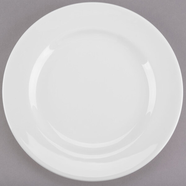 A white Libbey porcelain plate with a wide rim on a gray surface.