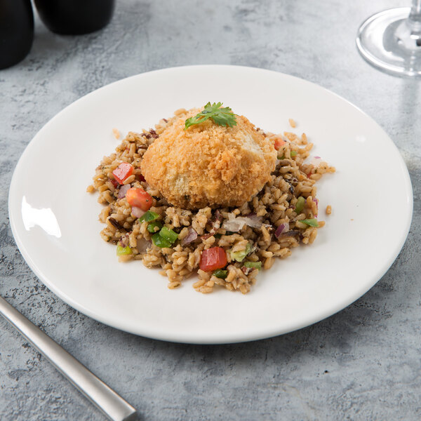 A Libbey white porcelain coupe plate with a fried meatball and rice on it.