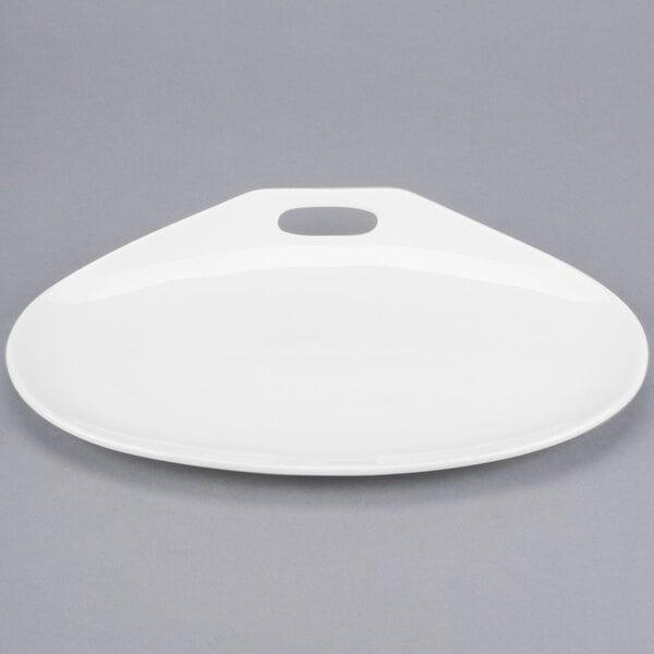 A white oval porcelain plate with a handle.