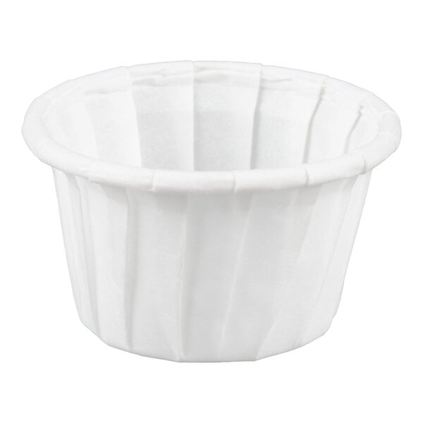 A small white paper souffle or portion cup.