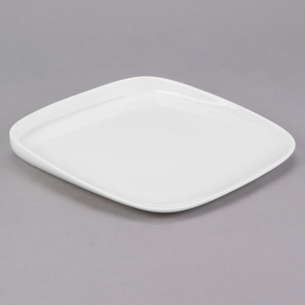 A white square Libbey porcelain plate with a small rim on a gray surface.