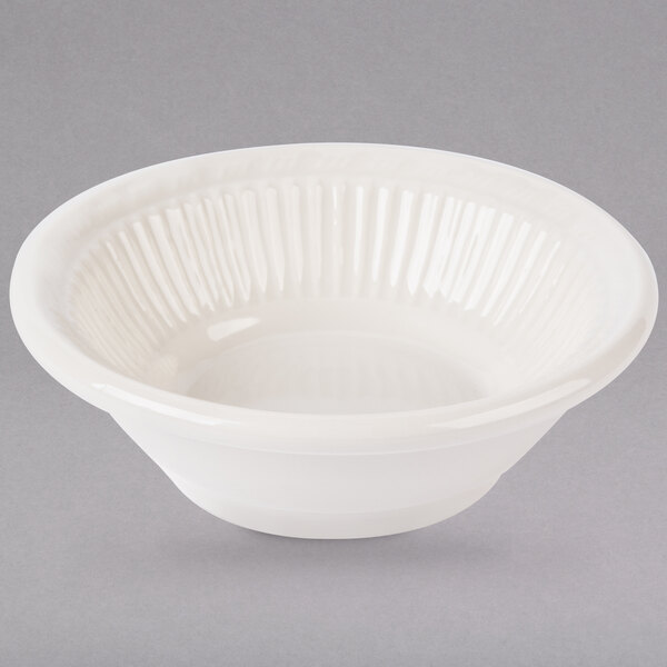 A white Tuxton Hampshire fruit bowl with a rippled edge.