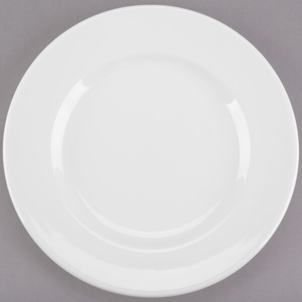A white Libbey porcelain plate with a wide rim on a gray surface.