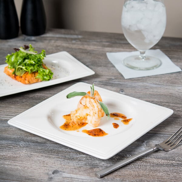 A Libbey square porcelain plate with food and a fork on it.