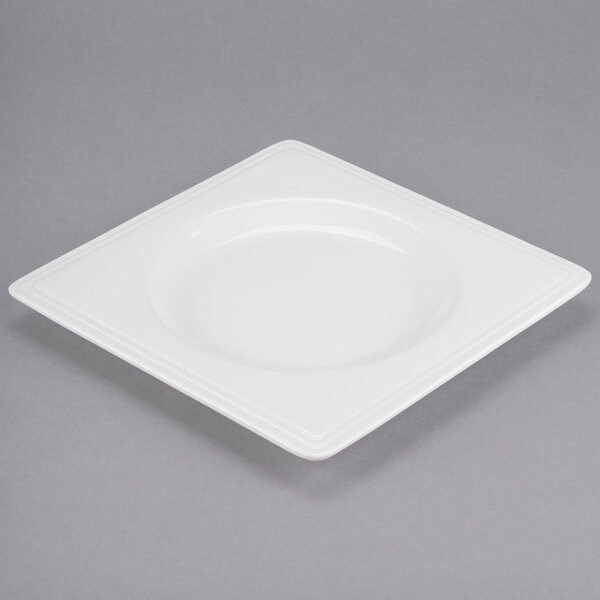 A white square Libbey porcelain plate with a wide white rim.