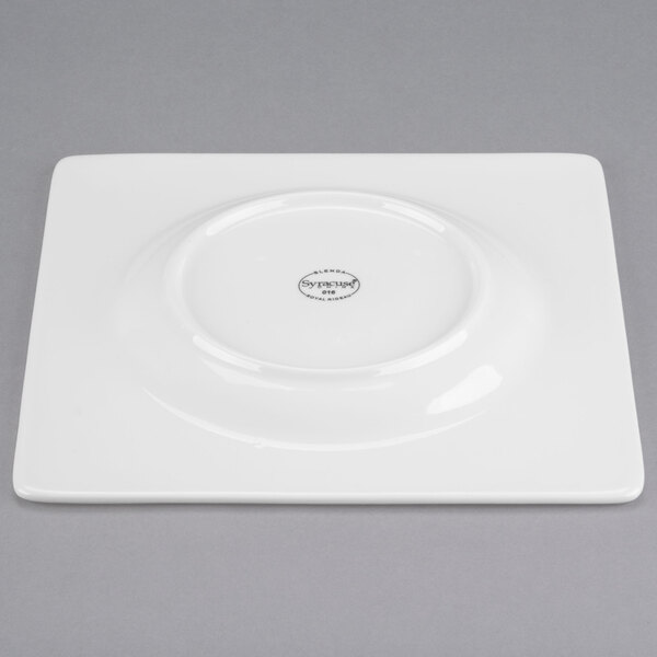 A white square porcelain plate with a circular design.