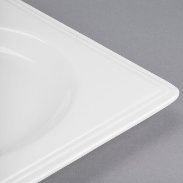 A close-up of a white square Libbey Slenda Valla porcelain plate with a square edge.