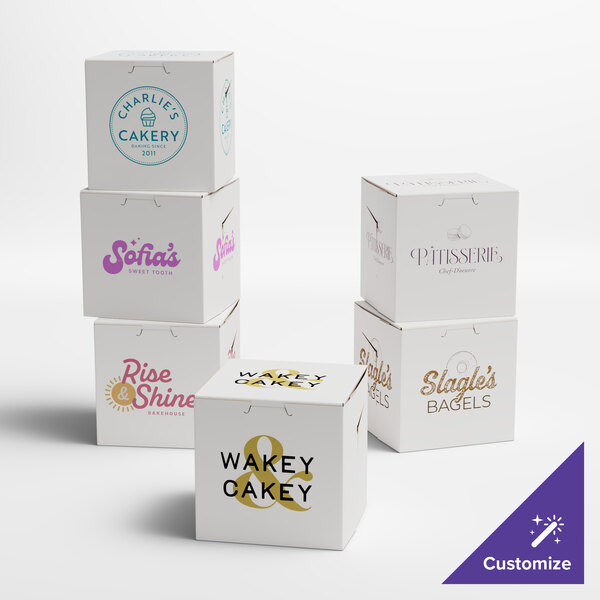 A group of white customizable cupcake boxes with different colored text on them.