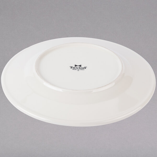 A white Tuxton Hampshire china plate with a black embossed rim.