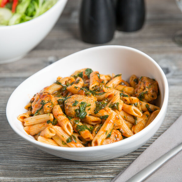 A bowl of pasta with meatballs and sauce in a Libbey Royal Rideau white porcelain bowl.