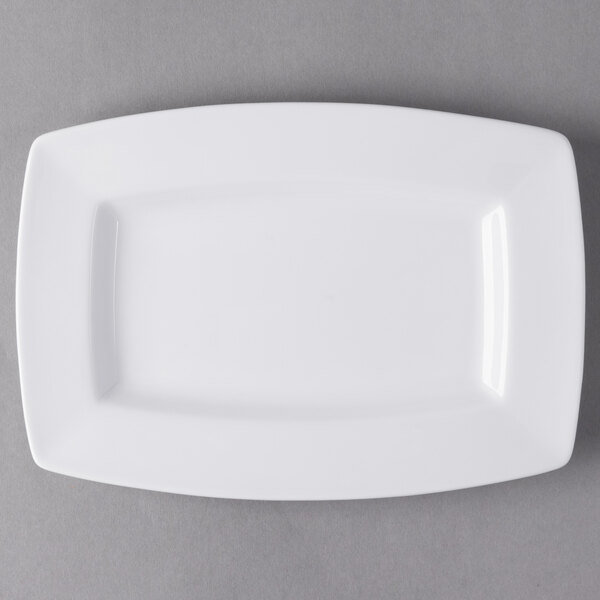 A white rectangular Libbey Slenda porcelain plate with a wide rim on a gray surface.