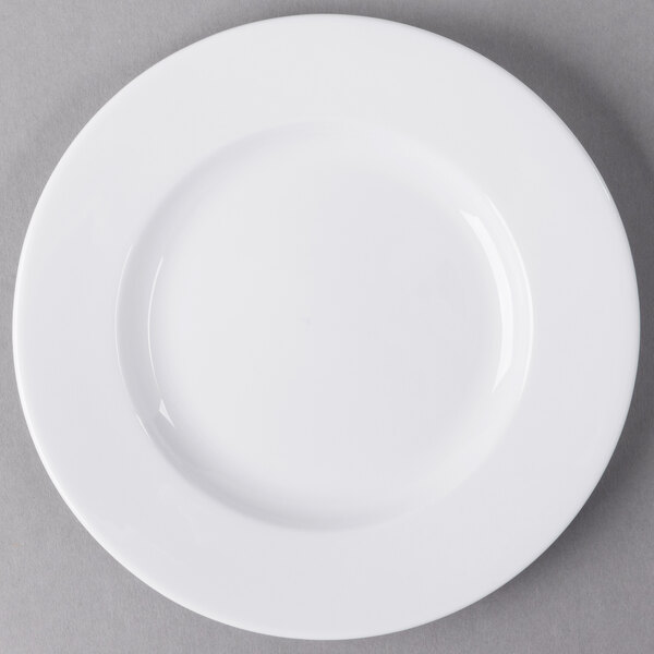 A Libbey white porcelain plate with a white rim on a gray surface.