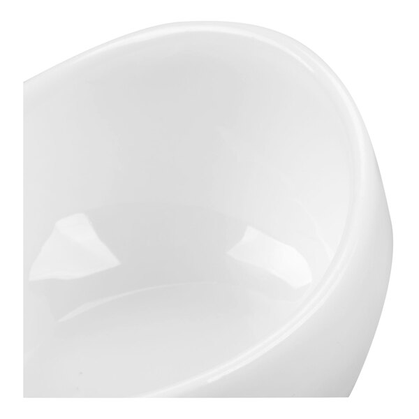 A close-up view of a glossy white, curved porcelain bowl.