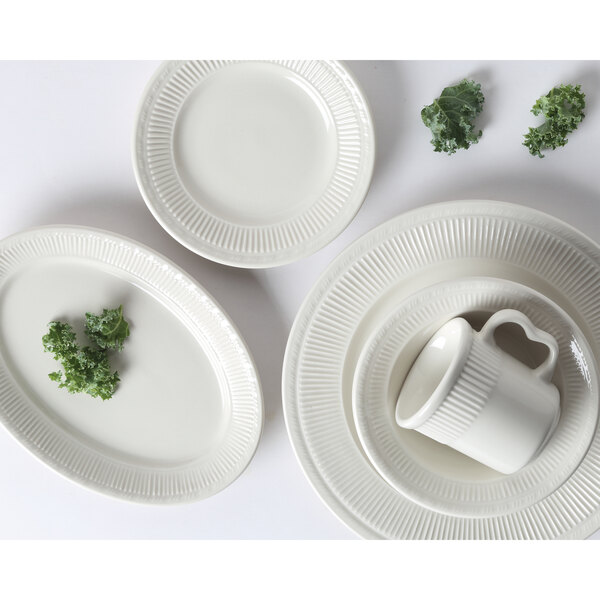 A close-up of a Tuxton Hampshire white china bowl with an embossed rim.