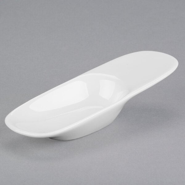 A white Libbey Royal Rideau porcelain spoon with a curved bowl.