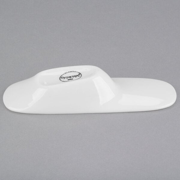 A close-up of a Libbey white porcelain amuse bouche spoon.